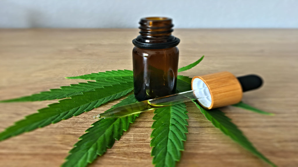 cbd oil in tincture with cannabis leaf