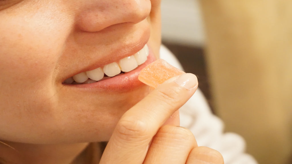 A woman eating a CBD gummy - Full-Spectrum vs. Broad-Spectrum vs. CBD Isolate
