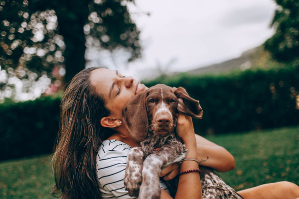 Gril Hugging a Dog - CBD Oil For Dogs With Cancer