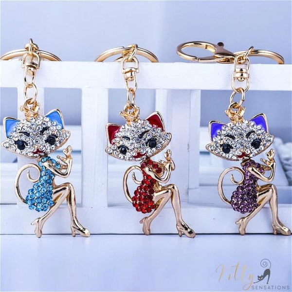 3 cat lady keychains in blue red and purple