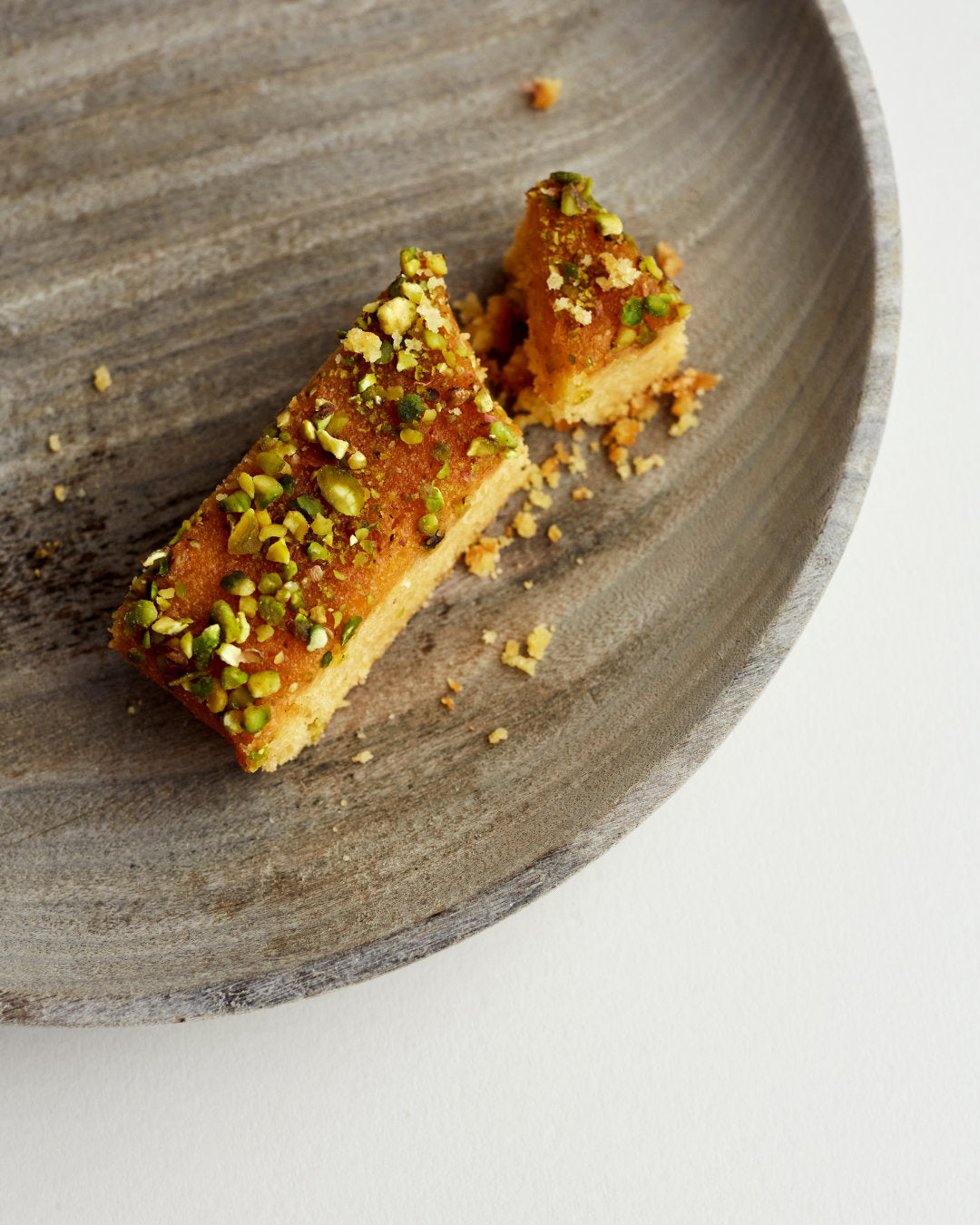 A single portion of the Exploding Bakery Lemon Polenta and Pistachio Cake.