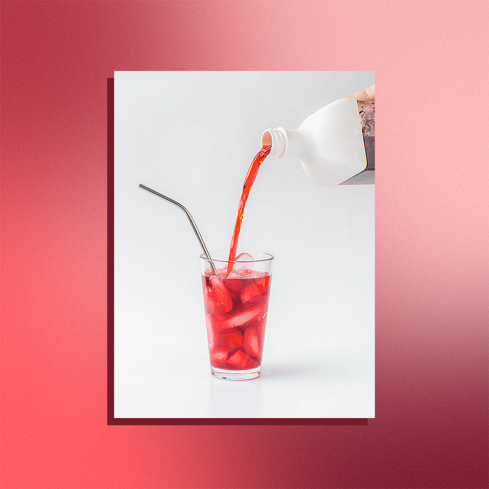 Image of cold brew tea being poured into a glass on a mesh gradient background.
