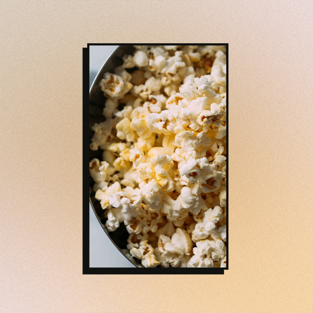 An image of popcorn on a mesh gradient background.