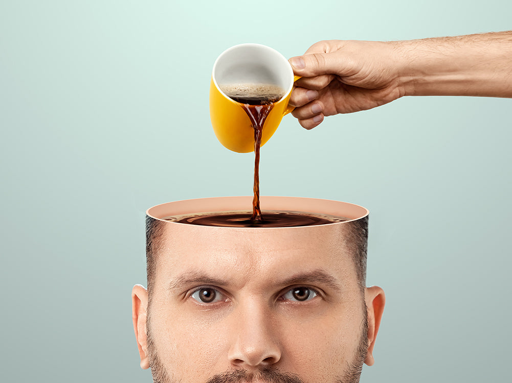 An image of a hand pouring coffee into a man's head.