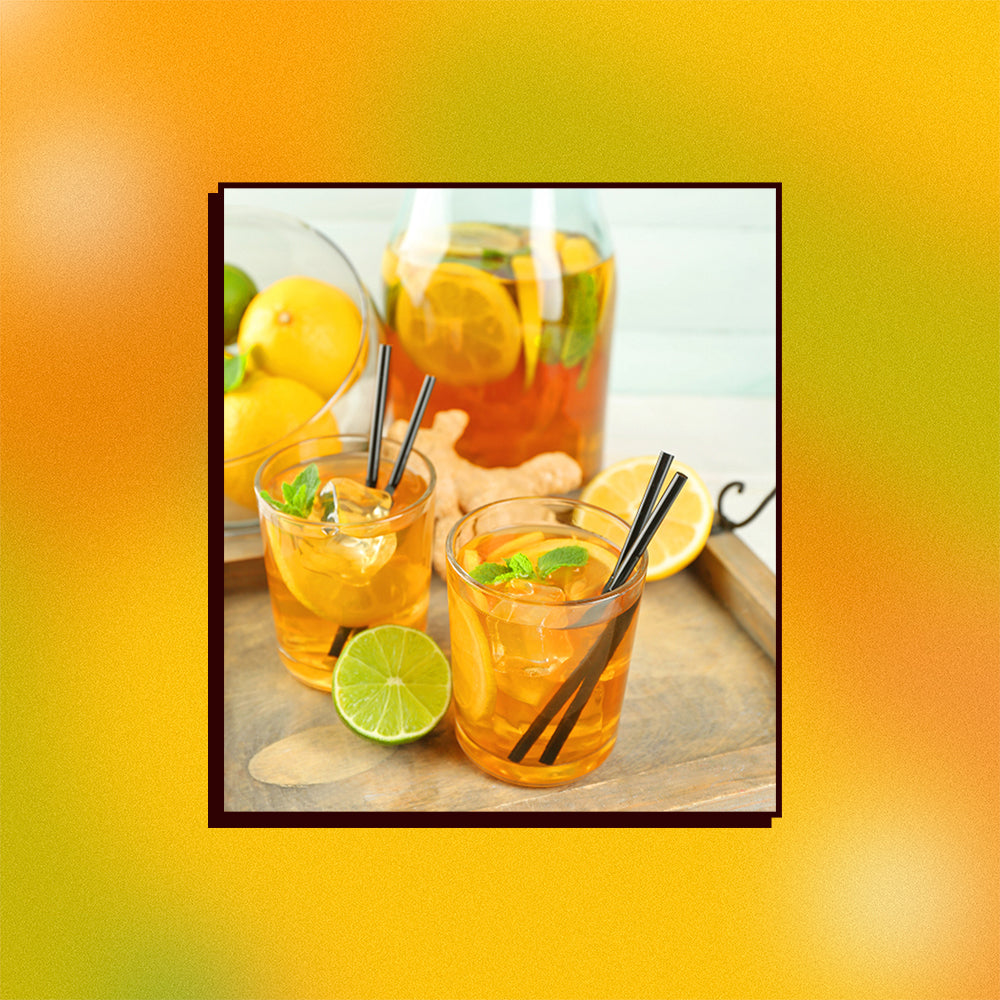 An image of two ginger mate spritzers in front of a pitcher on a wooden tray on a mesh gradient background.