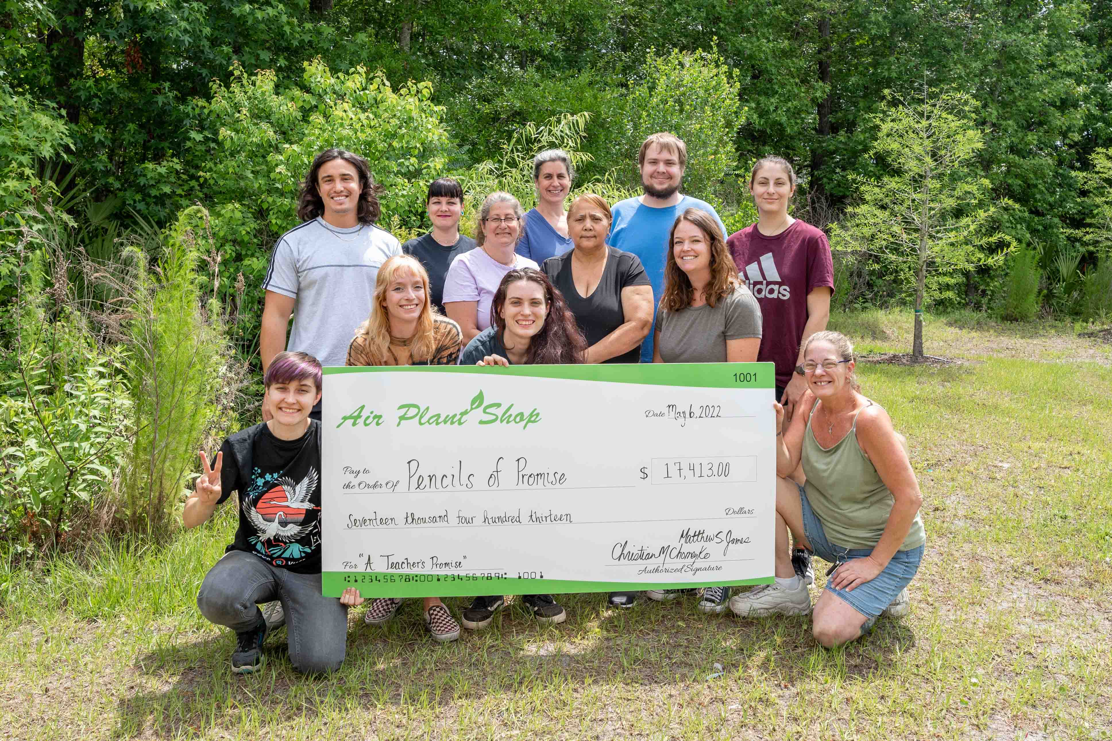 Air Plant Shop Staff with Check for Pencils of Promise Donation