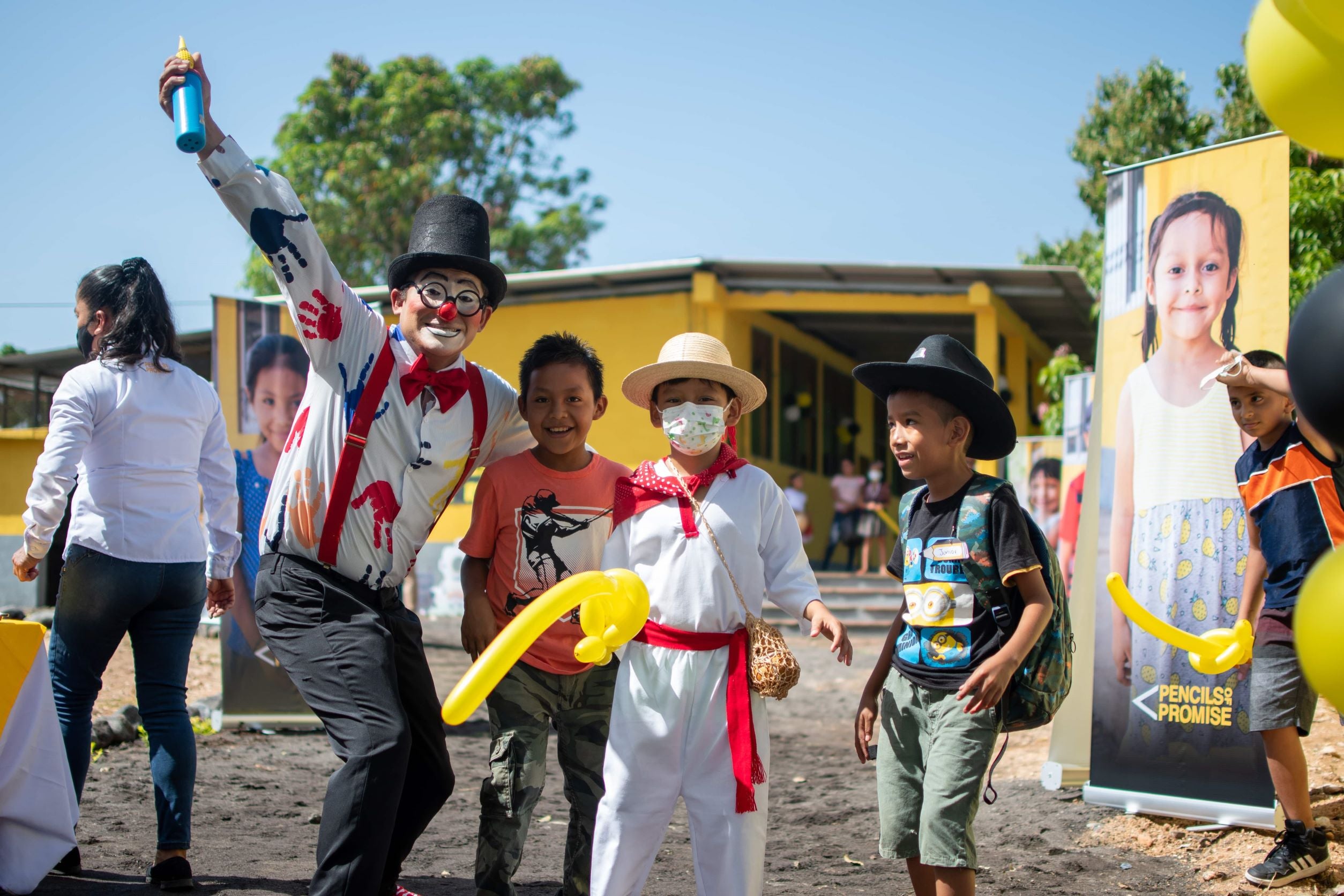 Children celebrating with the help of a cheerful clown