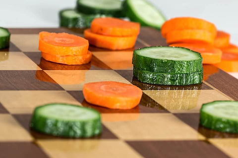 cucumber and carrot on chess board