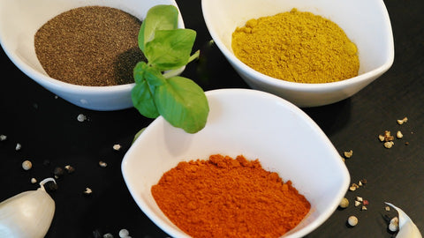powdered spices in white bowls