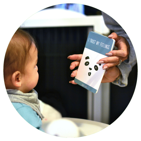 Mom shows baby Jenny & Andy's positive affirmation cards for kids. The card reads "I trust my feelings".