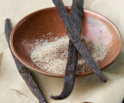 small wooden bowl, with 3 vanilla bean pods