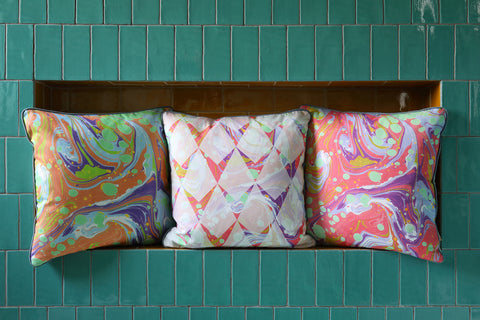 graphic marbled cushions against teal tiles