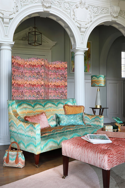 upholstered George Smith velvet sofa in large hallway entrance hall with vintage screen