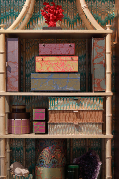 Bookshelf filled with luxury trinkets and beautiful box files
