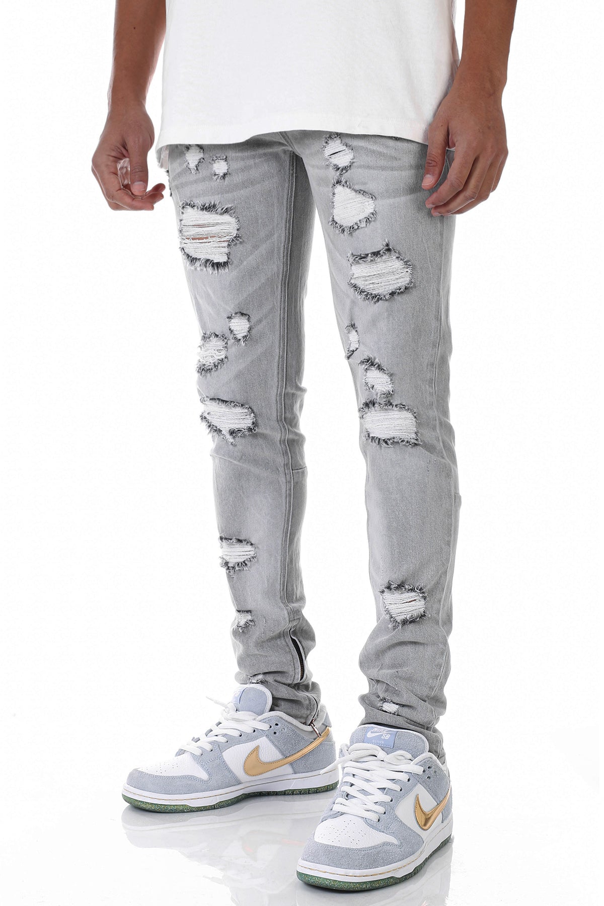 MULTI-DISTRESSED JEANS WITH ANKLED ZIPPERS