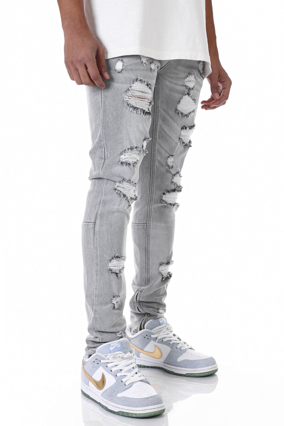 MULTI-DISTRESSED JEANS WITH ANKLED ZIPPERS