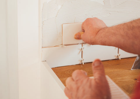 Man installing tile