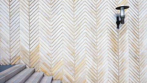 Staircase with herringbone tile on wall
