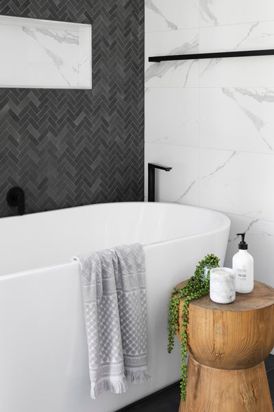 Bathroom with herringbone tile wall
