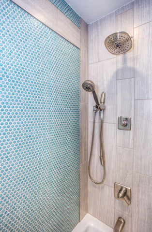 Shower with blue penny tile and larger neutral tile