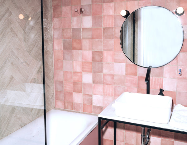 Bathroom with pink tile wall