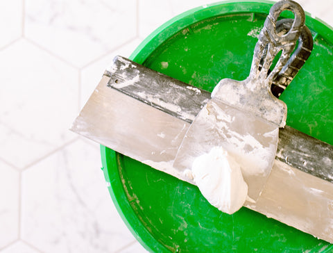 Bucket of grout with grout float