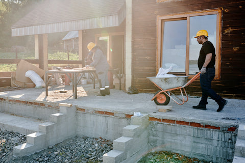 Workers preparing to install tile outdoors