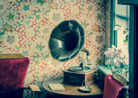 Gramophone in room with retro flower wallpaper