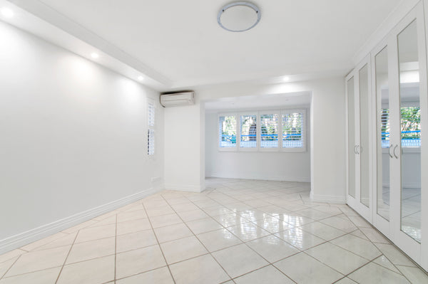 Room with white tile floor and white walls