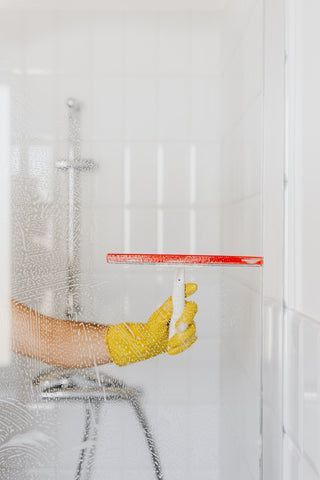 Person cleaning shower