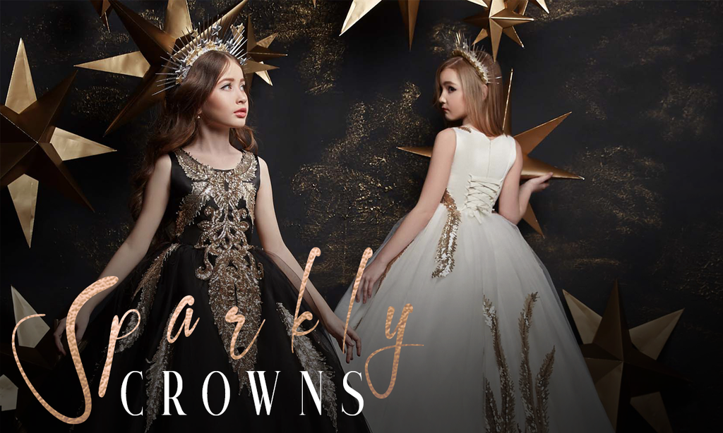 little girls model wearing black and white flower girl dresses with gold lace and crowns modeling for miele moda boutique