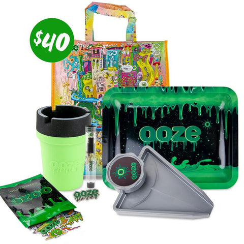 The Ooze 2020 $40 Dry Herb Grab Bag is pictured against a white background. This bundle includes the Oozeville reusable bag, Ooze logo rolling tray, grinder tray, Roadie silicone car ashtray, stickers and a hat pin.