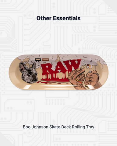 The RAW x Boo Johnson Skate Deck rolling tray is shown. It has a dripping RAW logo, image of a French bulldog's head, and who hands sparking a joint.