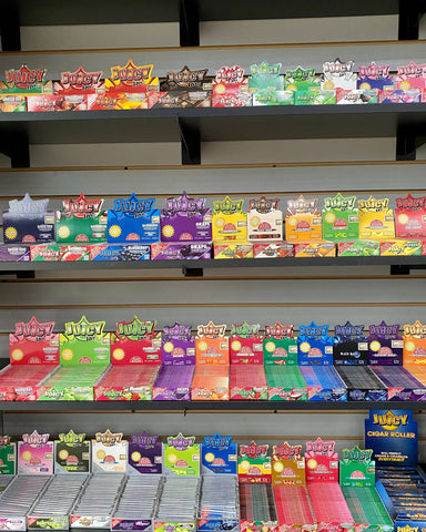 4 shelves are packed with all the different flavors of Juicy Jays rolling papers in the Canatron wholesale showroom.