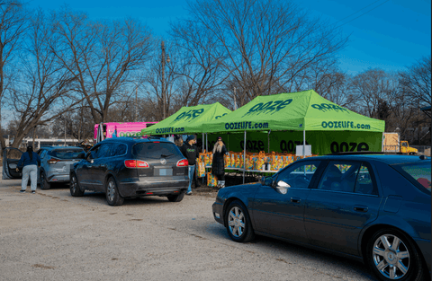 Cars are going through the Ooze Foundation Oozegiving food drive line to pick up their bag of Thanksgiving sides, turkey, and pie.