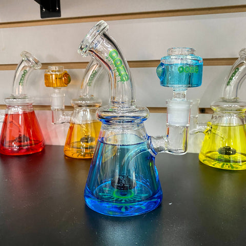 A shelf full of assorted colors of Ooze Glyco freeze bongs