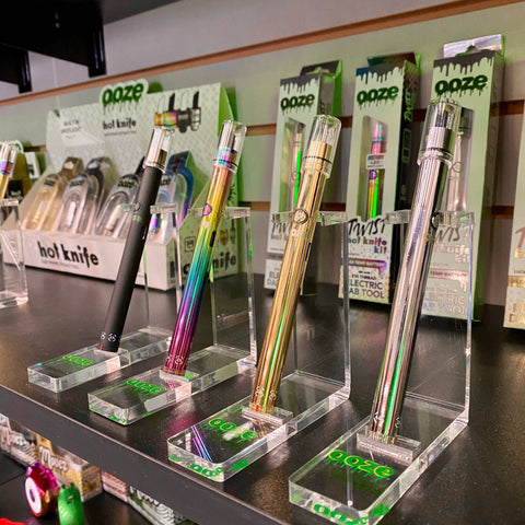 Four Ooze Twist Hot Knife kits are lined up on displays on a smoke shop shelf