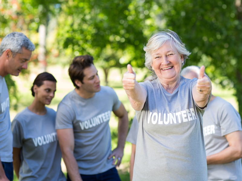 Senior volunteer giving two thumbs up