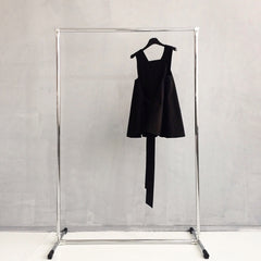 little black dress hanging on a rack