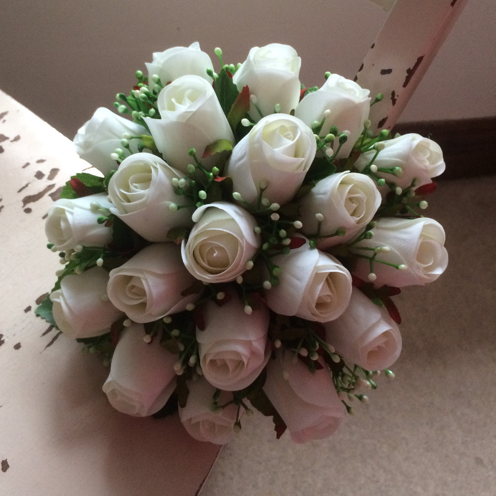A bridal bouquet featuring artificial silk white roses and gyp ...