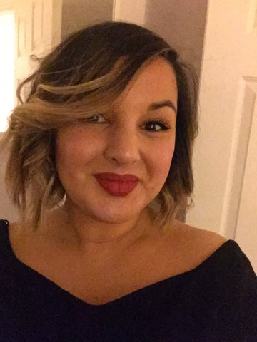 A woman with short hair wearing a black top and red lipstick - Josh Wood Hair Colour Expert