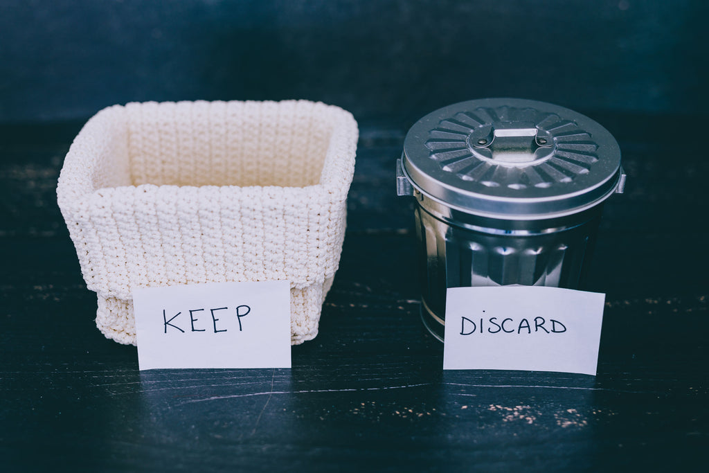 Two bins, one that is for keeping things in good condition and the other for discarding things that are not needed.