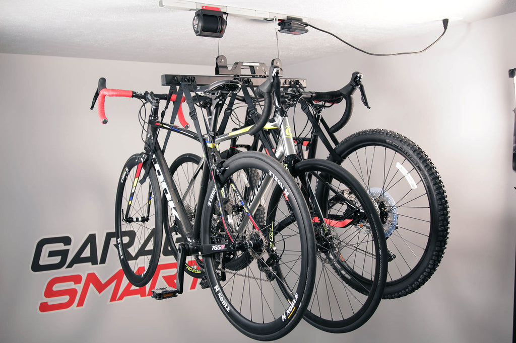  A Garage Smart bike rack that is pulling up three bikes for ideal garage storage. 