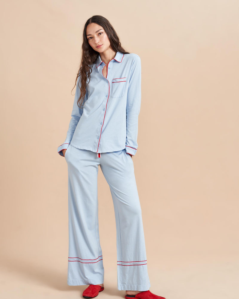 Pajama party ready. Our PJs are cut from our super soft t-shirt fabric for the ultimate in comfort and style when you need a little hygge. Pale blue cotton framed with contrasting red piping, our PJ set has a relaxed-fit top and elasticated drawstring wide-leg pants.