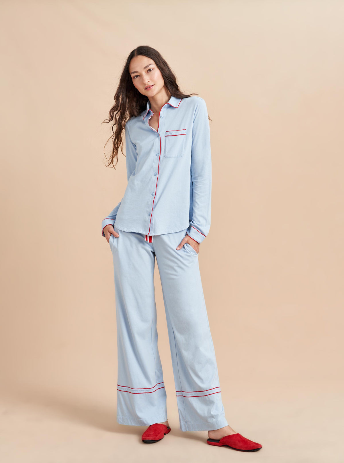 Pajama party ready. Our PJs are cut from our super soft t-shirt fabric for the ultimate in comfort and style when you need a little hygge. Pale blue cotton framed with contrasting red piping, our PJ set has a relaxed-fit top and elasticated drawstring wide-leg pants.