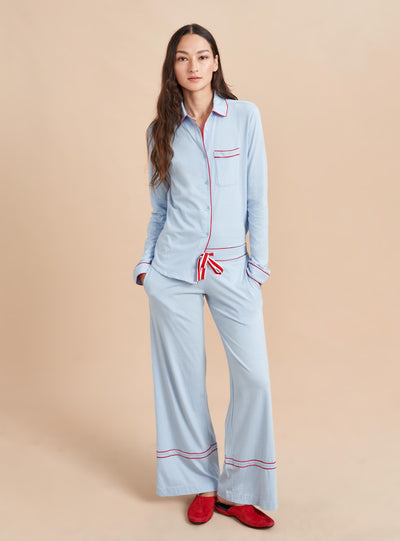 Pajama party ready. Our PJs are cut from our super soft t-shirt fabric for the ultimate in comfort and style when you need a little hygge. Pale blue cotton framed with contrasting red piping, our PJ set has a relaxed-fit top and elasticated drawstring wide-leg pants.