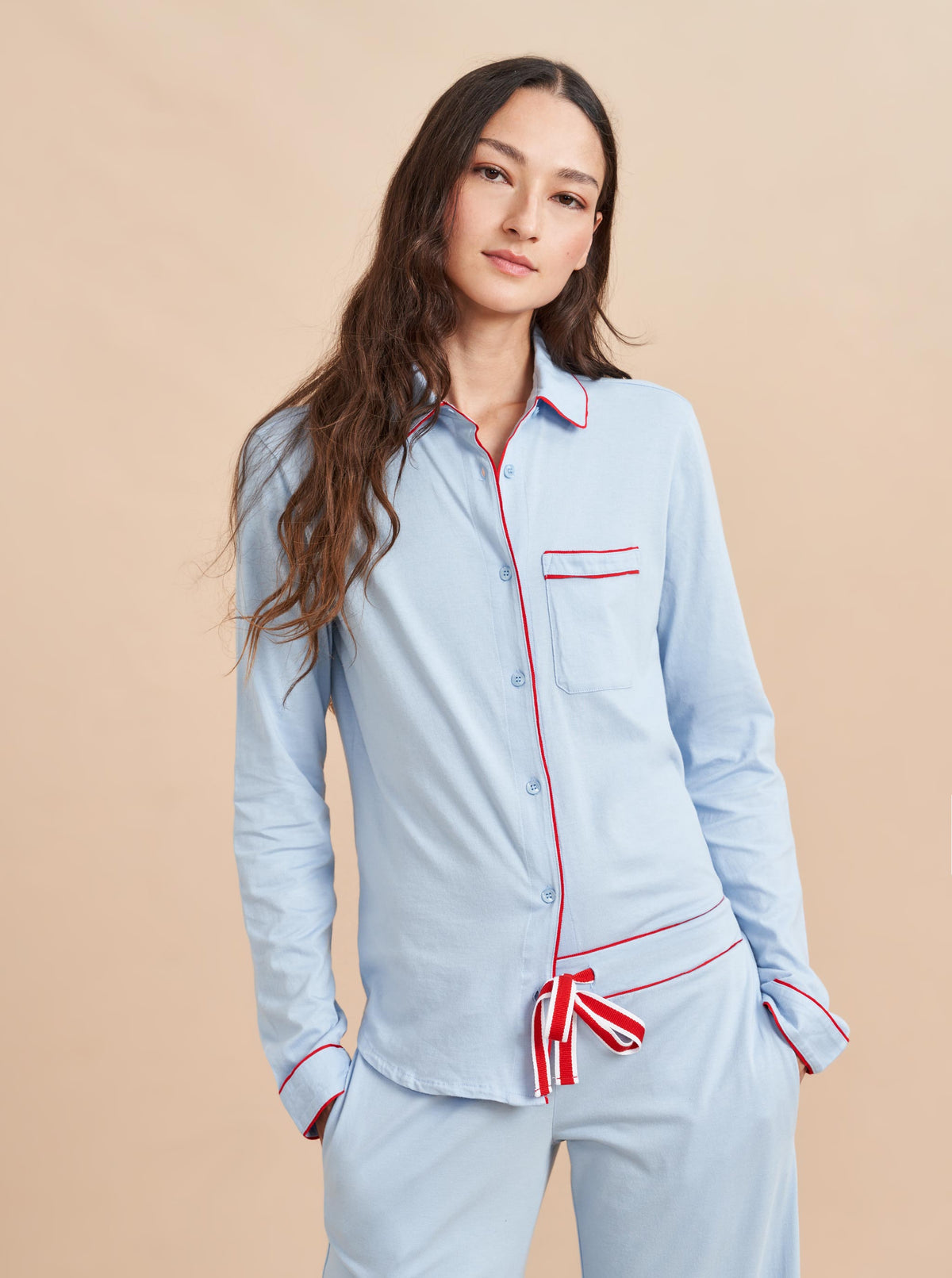 Pajama party ready. Our PJs are cut from our super soft t-shirt fabric for the ultimate in comfort and style when you need a little hygge. Pale blue cotton framed with contrasting red piping, our PJ set has a relaxed-fit top and elasticated drawstring wide-leg pants.