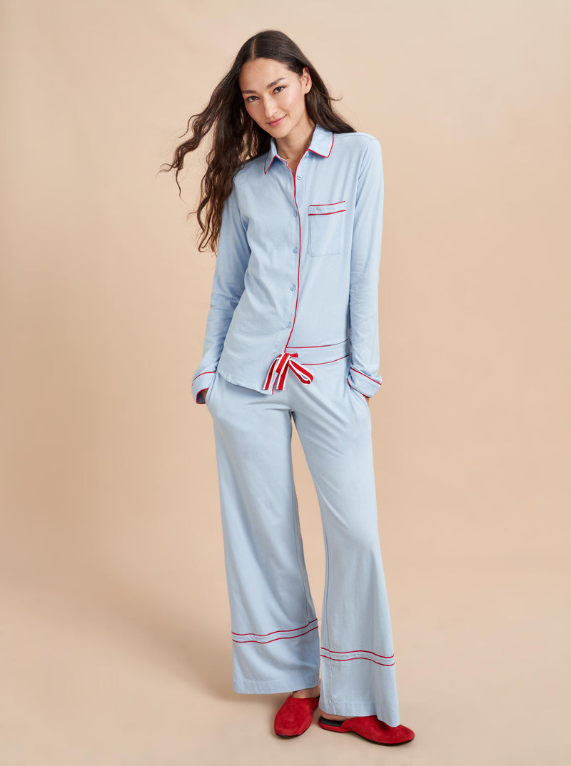 Pajama party ready. Our PJs are cut from our super soft t-shirt fabric for the ultimate in comfort and style when you need a little hygge. Pale blue cotton framed with contrasting red piping, our PJ set has a relaxed-fit top and elasticated drawstring wide-leg pants.