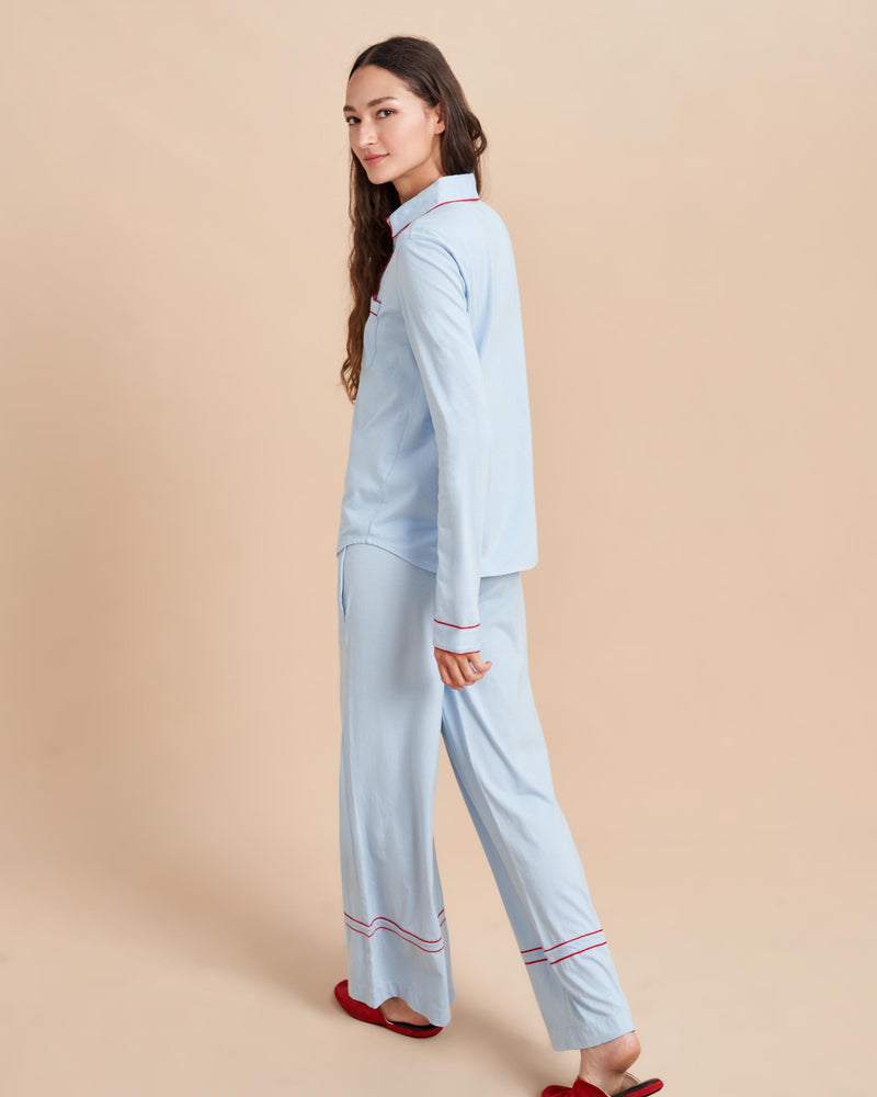 Pajama party ready. Our PJs are cut from our super soft t-shirt fabric for the ultimate in comfort and style when you need a little hygge. Pale blue cotton framed with contrasting red piping, our PJ set has a relaxed-fit top and elasticated drawstring wide-leg pants.