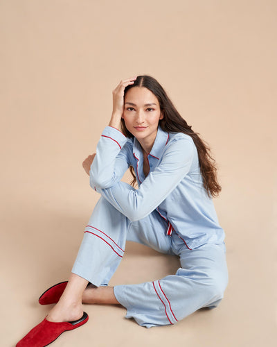 Pajama party ready. Our PJs are cut from our super soft t-shirt fabric for the ultimate in comfort and style when you need a little hygge. Pale blue cotton framed with contrasting red piping, our PJ set has a relaxed-fit top and elasticated drawstring wide-leg pants.